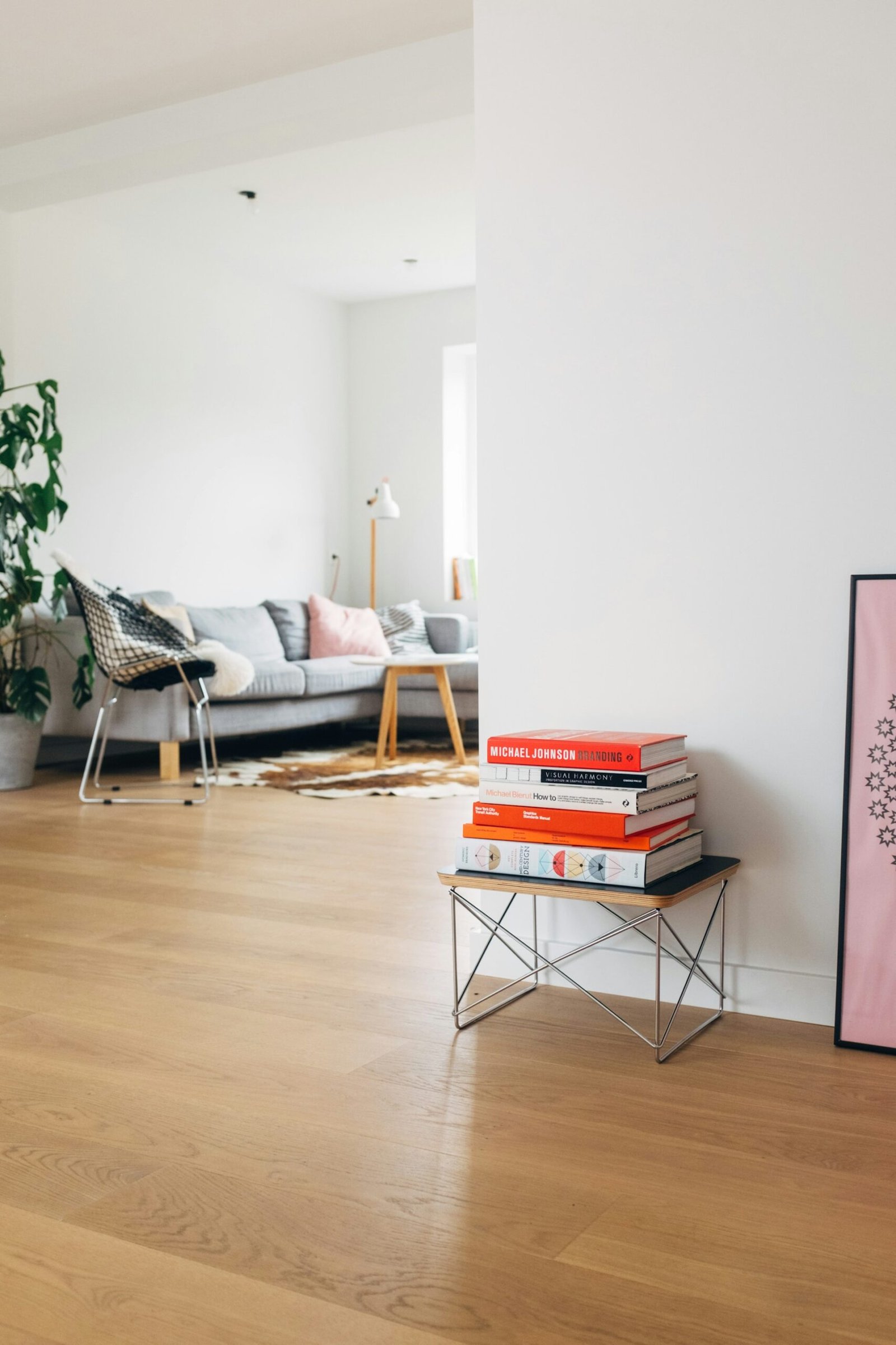 Bright living room with books stacked on table